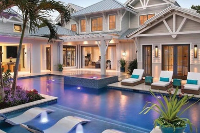 Inspiration for a large contemporary backyard tile and rectangular lap hot tub remodel