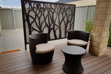 Inspiration for a small contemporary side yard screened-in verandah in Perth with decking.