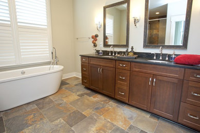 Example of a large classic master freestanding bathtub design in Other with shaker cabinets and medium tone wood cabinets