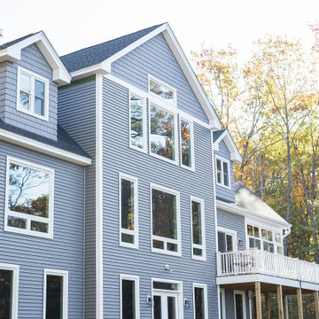 Large windows, gray CertainTeed Siding and shakes
