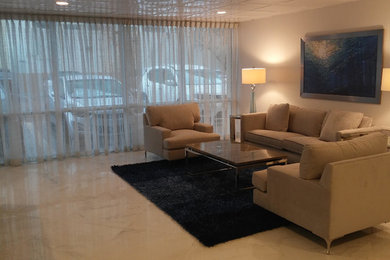 Living room - mid-sized transitional formal and enclosed marble floor and gray floor living room idea in Miami with beige walls