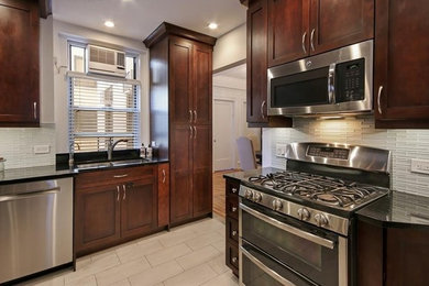 Inspiration for a small contemporary u-shaped porcelain tile enclosed kitchen remodel in New York with a double-bowl sink, shaker cabinets, medium tone wood cabinets, granite countertops, white backsplash, stainless steel appliances and no island