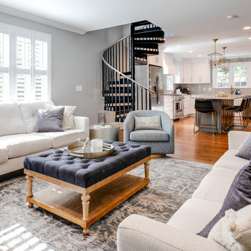 Bright Open-Concept Living Room with Spiral Staircase and Modern Kitchen