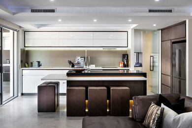 Inspiration for a large modern single-wall separate kitchen in Perth with a drop-in sink, louvered cabinets, white cabinets, granite benchtops, beige splashback, cement tile splashback, black appliances, terra-cotta floors and with island.