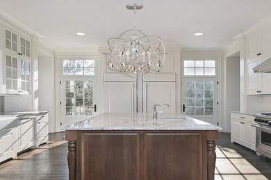 Inspiration for a large contemporary u-shaped medium tone wood floor kitchen remodel in New York with shaker cabinets, white cabinets, granite countertops, white backsplash, ceramic backsplash, stainless steel appliances and an island