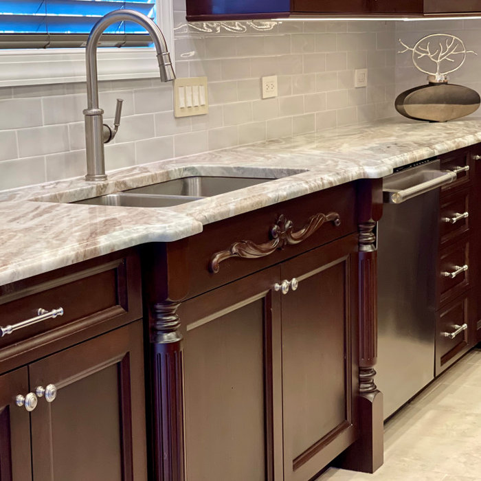 Large elegant porcelain tile and beige floor eat-in kitchen photo in Philadelphia with a double-bowl sink, flat-panel cabinets, brown cabinets, granite countertops, gray backsplash, glass tile backspl