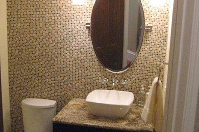 Doorless shower - doorless shower idea in Orlando with shaker cabinets, dark wood cabinets, granite countertops and beige walls