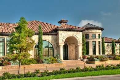 Example of a huge classic beige two-story stone exterior home design in Dallas with a hip roof