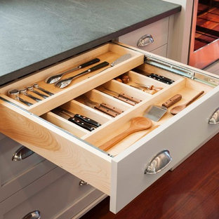 Large modern kitchen pantry inspiration - Example of a large minimalist u-shaped dark wood floor kitchen pantry design in Burlington with a farmhouse sink, flat-panel cabinets, white cabinets, wood countertops, multicolored backsplash, paneled appliances and an island
