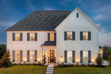 Example of a large transitional white two-story brick exterior home design in Dallas with a shingle roof