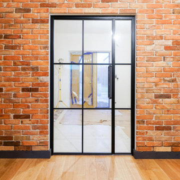 Industrial-style steel doors with an opening panel
