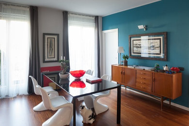 Large modern open plan dining in Milan with blue walls, dark hardwood floors and brown floor.