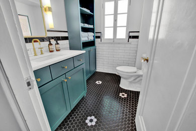 Inspiration for a mid-sized transitional master black and white tile mosaic tile floor, multicolored floor and single-sink bathroom remodel in St Louis with green cabinets, a one-piece toilet, white walls, a hinged shower door and a built-in vanity