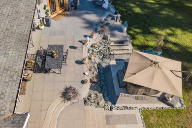 Example of a backyard concrete paver patio design in Seattle