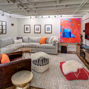 Urban basement in DC Metro with white walls, medium hardwood flooring and brown floors.