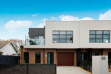 Contemporary two-storey brick brown exterior in Melbourne with a flat roof.