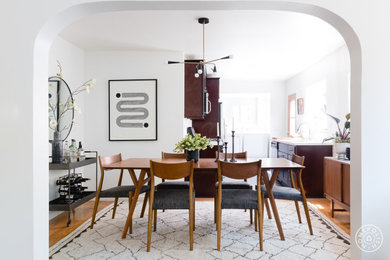 Example of a small eclectic dark wood floor and brown floor enclosed dining room design in Los Angeles with white walls and no fireplace