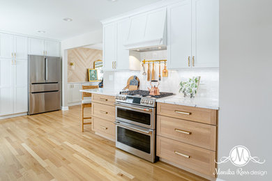 Inspiration for a large transitional galley light wood floor and beige floor kitchen pantry remodel in Chicago with an undermount sink, shaker cabinets, light wood cabinets, quartz countertops, white backsplash, ceramic backsplash, stainless steel appliances, no island and white countertops