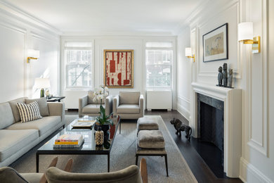 Transitional formal and enclosed dark wood floor, brown floor and wall paneling living room photo in New York with white walls, a standard fireplace, a stone fireplace and no tv