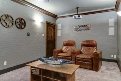 Photo of a mid-sized traditional enclosed home theatre in Dallas with grey walls, carpet and grey floor.