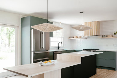 Eat-in kitchen - mid-sized contemporary l-shaped light wood floor eat-in kitchen idea in Nashville with an undermount sink, flat-panel cabinets, quartz countertops, white backsplash, ceramic backsplash, stainless steel appliances, an island and white countertops