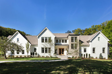 Transitional white two-story house exterior idea in Nashville with a shingle roof and a brown roof