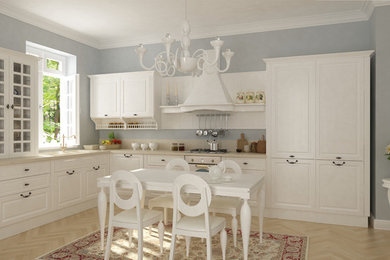 Inspiration for a timeless light wood floor eat-in kitchen remodel in Other with white cabinets, blue backsplash, stainless steel appliances, no island and quartzite countertops