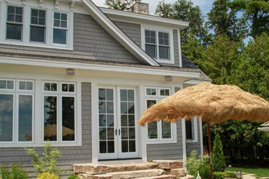 Patio - mid-sized coastal backyard stone patio idea in Toronto