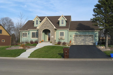 Photo of a mid-sized traditional two-storey exterior in Minneapolis with wood siding and a gable roof.