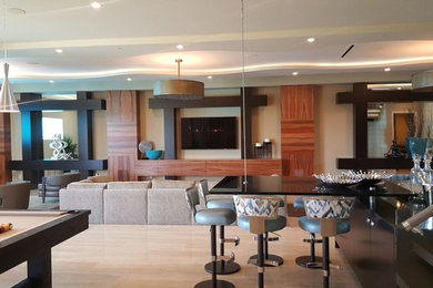 Inspiration for a large contemporary open concept light wood floor living room remodel in Las Vegas with beige walls and a wall-mounted tv
