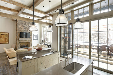 Inspiration for a large contemporary dark wood floor and brown floor open concept kitchen remodel in Denver with a farmhouse sink, shaker cabinets, light wood cabinets, granite countertops, white backsplash, stone slab backsplash, stainless steel appliances and two islands