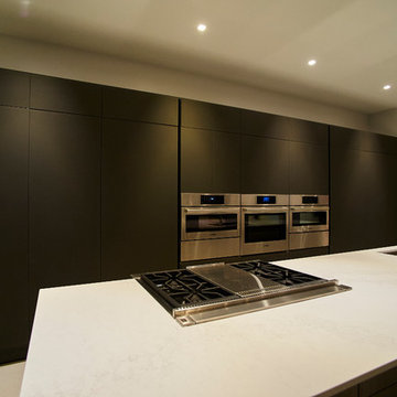 Professional Kitchen with Integrated Gas Cooktop and Full Wall Ovens