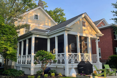 Inspiration for a victorian screened-in and wood railing back porch remodel in Cincinnati with decking and a roof extension