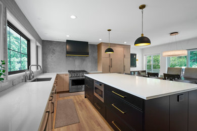 Inspiration for a large modern l-shaped light wood floor and brown floor eat-in kitchen remodel in Chicago with an undermount sink, flat-panel cabinets, quartz countertops, gray backsplash, stone slab backsplash, paneled appliances, an island, white countertops and black cabinets