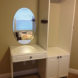 Master closet vanity with oval mirror. - Closet Storage
