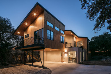 Inspiration for a contemporary brown two-story mixed siding house exterior remodel in Austin with a shed roof