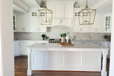 Photo of an expansive classic u-shaped kitchen/diner in Baltimore with a belfast sink, shaker cabinets, white cabinets, engineered stone countertops, white splashback, metro tiled splashback, stainless steel appliances, medium hardwood flooring, an island, brown floors, white worktops and a drop ceiling.