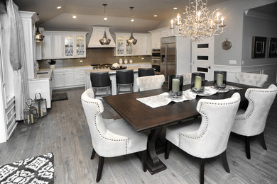 Example of a large classic u-shaped eat-in kitchen design in Chicago with recessed-panel cabinets, white cabinets, quartzite countertops and an island