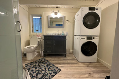 Small country vinyl floor, single-sink and exposed beam bathroom photo in Other with blue cabinets, a two-piece toilet, white walls, an integrated sink and a freestanding vanity