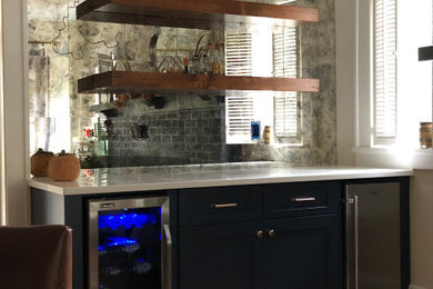 Wet bar - small modern wet bar idea in New York with no sink, raised-panel cabinets, black cabinets, quartzite countertops and white countertops