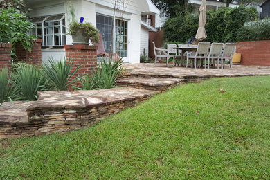 Inspiration for a mid-sized timeless backyard stone patio remodel in Atlanta with no cover