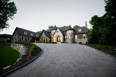 Example of a huge classic brown two-story brick exterior home design in Detroit with a shingle roof