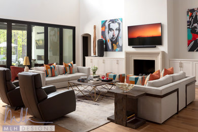 Minimalist medium tone wood floor living room photo in Little Rock with a standard fireplace, a concrete fireplace and a wall-mounted tv