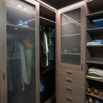 Modern Wood Tone Walk-in Closet and Laundry Room with Frosted Glass Inserts