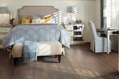 Example of a mid-sized transitional master dark wood floor and brown floor bedroom design in Denver with beige walls