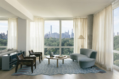 Example of a mid-sized minimalist open concept light wood floor living room design in New York with white walls