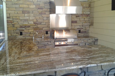 Kitchen - mid-sized rustic u-shaped brick floor kitchen idea in Tampa with an undermount sink, stainless steel cabinets, laminate countertops, stone tile backsplash and stainless steel appliances