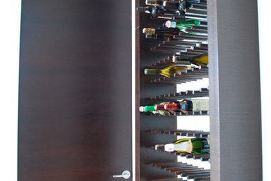 Example of a small minimalist light wood floor wine cellar design in Chicago with storage racks