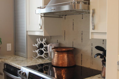 Small eclectic galley concrete floor and brown floor eat-in kitchen photo in Austin with a double-bowl sink, shaker cabinets, white cabinets, granite countertops, beige backsplash, glass tile backsplash, stainless steel appliances and no island