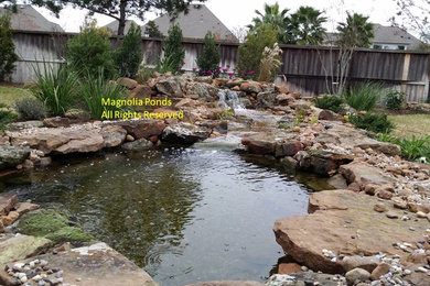 Inspiration for a mid-sized traditional partial sun backyard brick water fountain landscape in Houston.